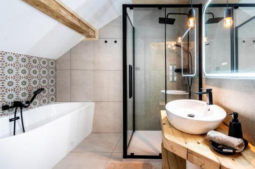 a bathroom with a tub and a sink and a shower at Kamp Soblówka in Sablówka