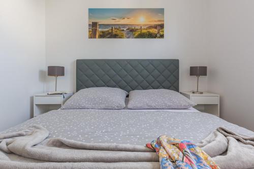 a bedroom with a large bed with two night stands at FeWo Sanfte Brise im EG mit Blick in die Natur in Göhren-Lebbin