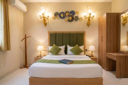 a bedroom with a large bed with a book on it at Swaranjali in Chikhli