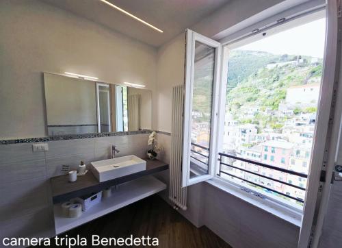 a bathroom with a sink and a large window at Affittacamere Benedetta e Isabelle in Vernazza
