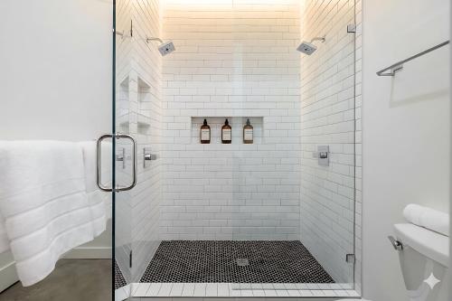 a bathroom with a shower with a glass door at The 121 Hotel in Nashville
