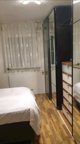 a bedroom with a bed and a dresser and a mirror at Billet Senior in Fredrikstad