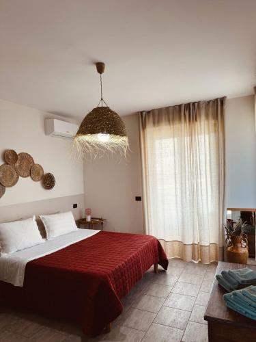 a bedroom with a large bed with a red blanket at Dimora da Adele in Termoli