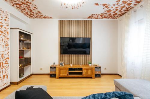 a living room with a flat screen tv on a wall at Almeida's House in Figueira da Foz