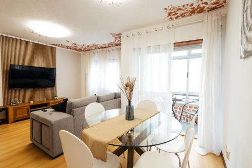 a living room with a table and a couch at Almeida's House in Figueira da Foz
