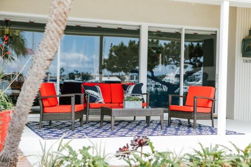 a group of chairs and a table on a porch at 1400 South Bayfront in Newport Beach