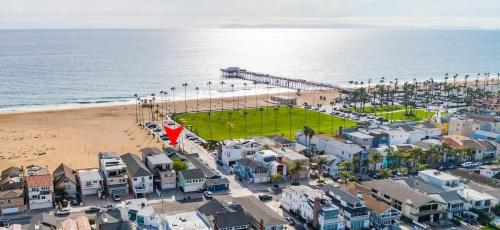 an aerial view of a beach with a pier at 1002 East Oceanfront in Newport Beach