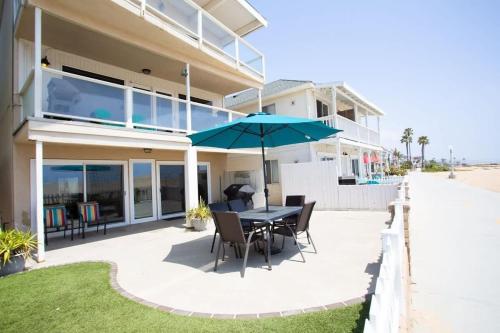 a patio with a table and chairs and an umbrella at 1005 E Balboa Unit A Lower #1 in Newport Beach