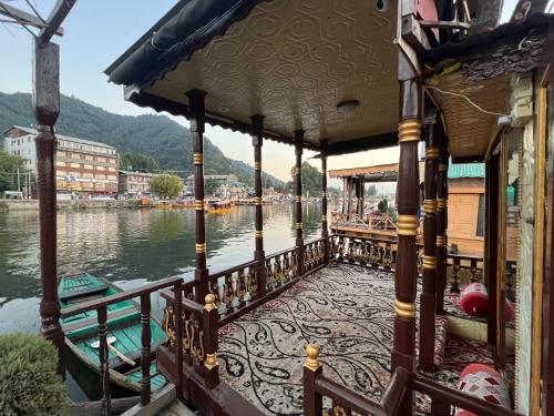a boat on a river with mountains in the background at FREEDOM houseBoat in Srinagar