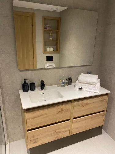 a bathroom with a sink and a mirror at Hilton Tanger View Tower 15D in Tangier