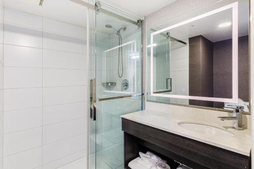 a bathroom with a sink and a glass shower at Hotel Classique in Quebec City