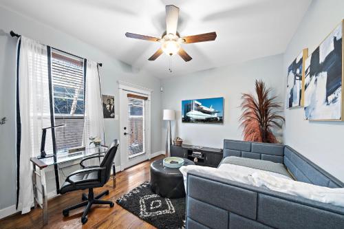 a living room with a couch and a desk and a ceiling fan at Near Heights, DT, Montrose, Washington BBQ WiFi in Houston