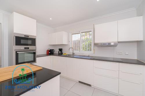 a kitchen with white cabinets and a counter top at Villa Reyets 4 bed 3 bath Private Pool in Busot