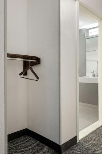 a bathroom with a closet with a mirror and a sink at Courtyard by Marriott Boston Norwood/Canton in Norwood
