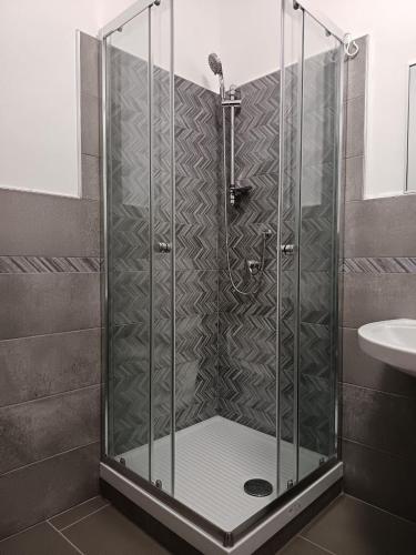 a shower with a glass door in a bathroom at B&B Belvedere in Monreale