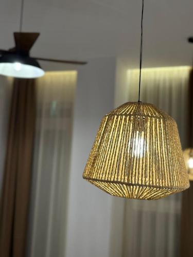a close up of a hanging gold light fixture at Palm Paradise Apartaments in Golem