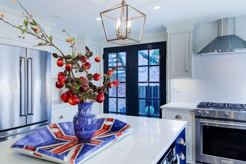 a kitchen with a vase with fruit on a counter at THE LIBERTY HOUSE Of Old Town Designer Home in Alexandria