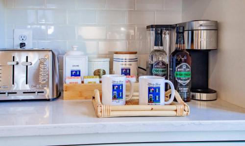 a kitchen counter with two coffee mugs on a counter at THE LIBERTY HOUSE Of Old Town Designer Home in Alexandria