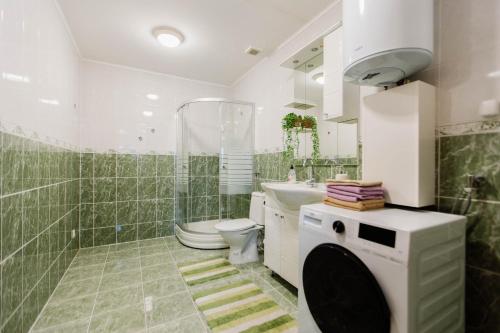 a bathroom with a toilet and a shower and a sink at Mia in Livno