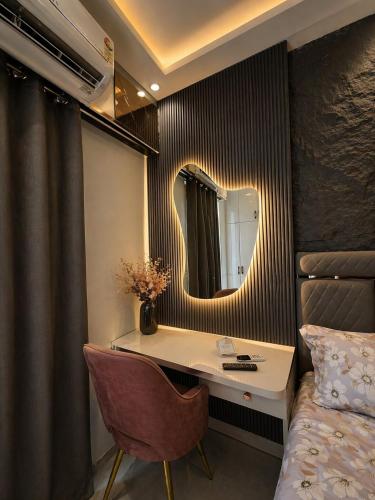 a bedroom with a dressing table and a mirror at Skyline suites in Noida