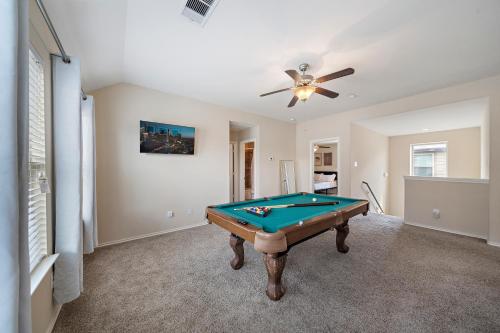 a pool table in a room with a ceiling fan at Near IAH Houston Home Yard BBQ Games Wi-Fi Pets in Houston