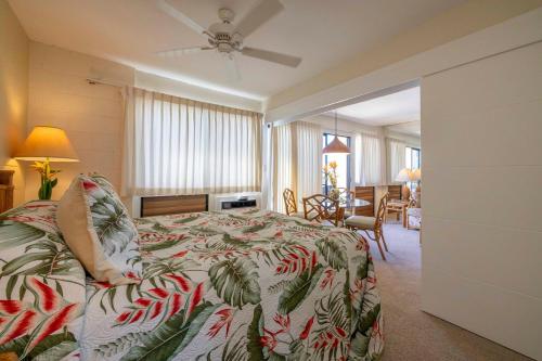 a bedroom with a bed and a living room at Hono Kai Resort B7 in Wailuku