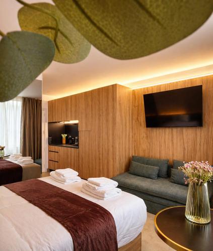 a hotel room with a bed and a couch at Miriam by Dozzze in Madrid