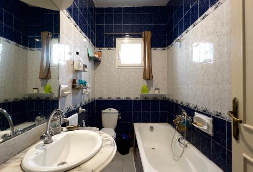 a bathroom with a sink and a tub and a toilet at Meraki house in La Marsa