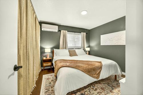 a bedroom with a bed and a window at Basecamp GP- Private Unit in Quiet Duplex Near Downtown in Grants Pass