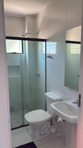a bathroom with a shower and a toilet and a sink at Apto lateral mar in Porto Belo