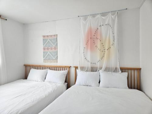 two beds sitting next to each other in a room at SNU Station 13min, Line 2, Hongdae,Gangnam 30min, 6pax in Seoul