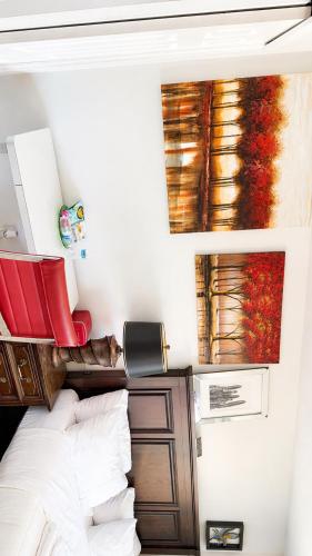 a bedroom with a bed and paintings on the wall at Penn Signature Airport Short Term Rental PHX in Phoenix