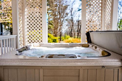 a jacuzzi tub on top of a porch at LMI -15- Laurel Falls Room: Summers Night in Lookout Mountain