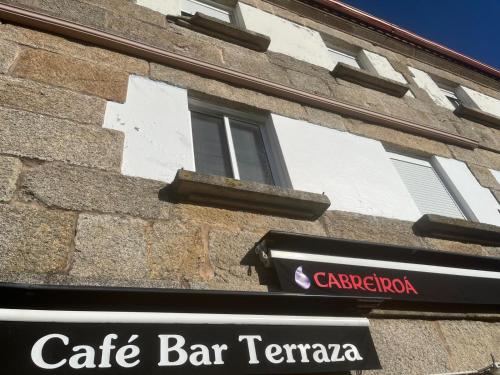 a building with a sign for a cafe bar terra at Pensión Restaurante Verdemar in Vigo