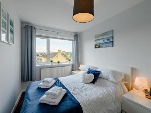 a bedroom with a bed with two towels on it at 3 Bed in Brixham oc-92770 in Brixham