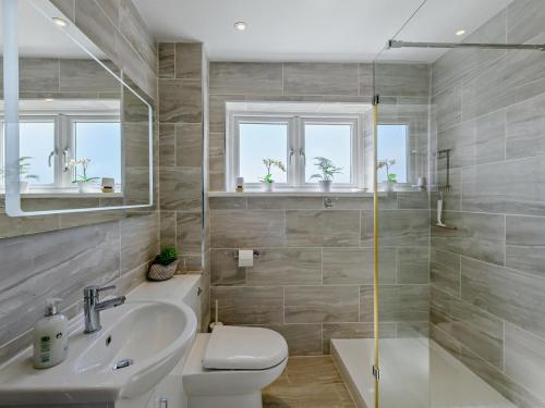 a bathroom with a sink and a toilet and a shower at 3 Bed in Brixham oc-92770 in Brixham