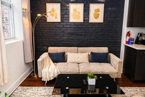 a living room with a couch and a black wall at Modern 2BR 420 Friendly in Chicago South Loop Near Museum Campus, McCormick Place and Soldier Field in Chicago