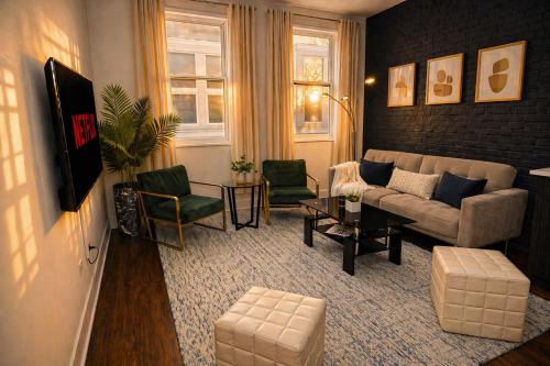 a living room with a couch and two chairs at Modern 2BR 420 Friendly in Chicago South Loop Near Museum Campus, McCormick Place and Soldier Field in Chicago