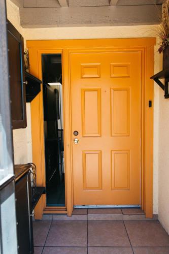 an orange door in a room with a tile floor at Desert Oasis Condo in Green Valley
