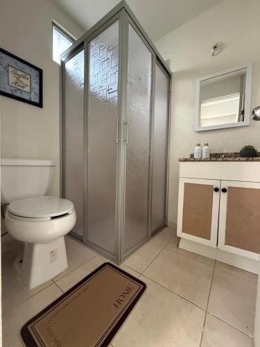 a bathroom with a shower and a toilet and a sink at Confortable estancia de 1 a 4 personas in Guamúchil