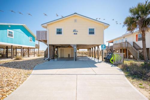 a house on the side of a street at Dip Inn by Oak Island Accommodations in Oak Island