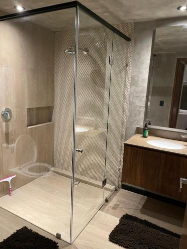 a bathroom with a shower and a toilet and a sink at PH 3-Bedroom Private Pool in TUK in Tulum
