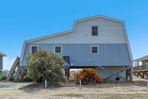 a large gray barn with a garage at Divine Intervention by Oak Island Accommodations in Oak Island