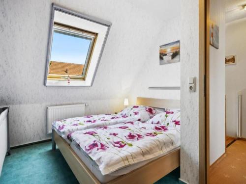 a bedroom with a bed and a window at Delphin in Pruchten