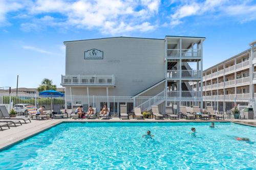 a swimming pool in front of a hotel at Dolphy Daze by Oak Island Accommodations in Oak Island