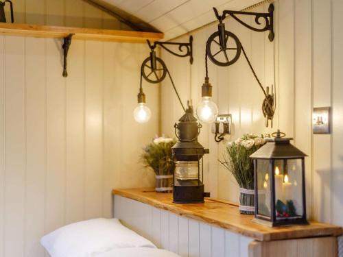 a room with a table with a lantern and lights at 1 Bed in Lydney oc-85862 in Bream