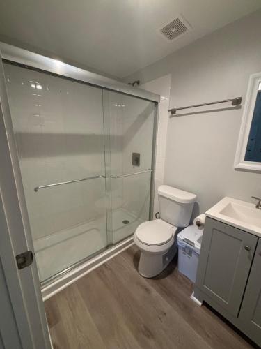 a bathroom with a shower and a toilet and a sink at Cozy Rooms in Decatur in Decatur