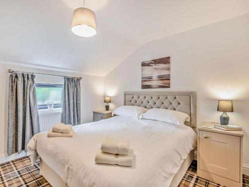 a bedroom with a large bed and a window at 2 Bed in Sheffield oc-92978 in Langsett