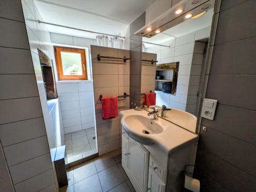 a white bathroom with a sink and a mirror at Gîte paisible dans ancienne ferme comtoise avec animaux acceptés - FR-1-583-416 in Saint-Bresson
