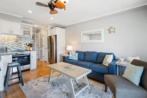 a living room with a blue couch and a table at New Listing - Spring Discounts Beach View Condo in Hilton Head Island